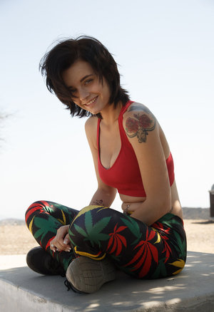 Brunette female Kirsten Price peels off sports bra and spandex to pose nude